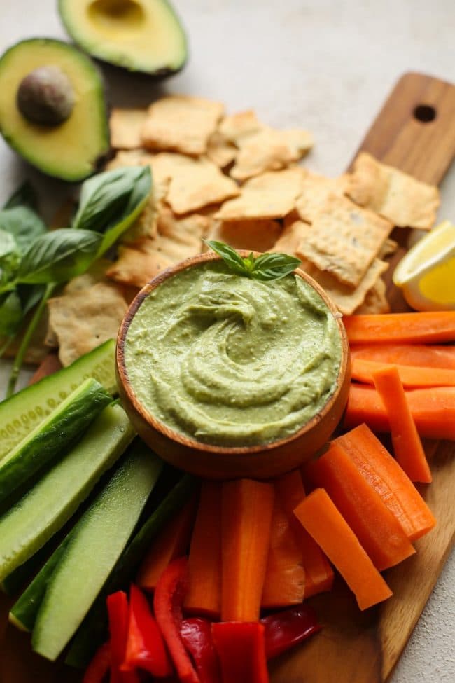 Basil Avocado Dip on a serving platter with fresh veggies