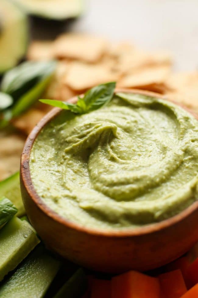 Creamy Basil Avocado Dip topped with fresh basil