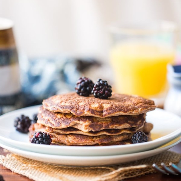 Coconut Flour Pancakes in a plate topped with blackberries