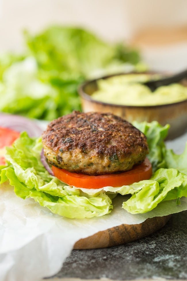 protein style turkey burger: burger patty in a lettuce wrap with tomatoes and onion - no bread