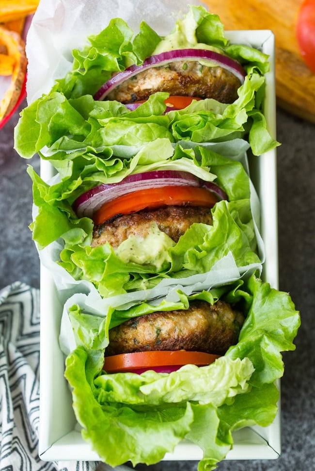 three paleo turkey burgers in lettuce wraps