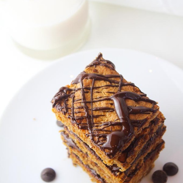 peanut butter oatmeal bars with chocolate drizzled over the top