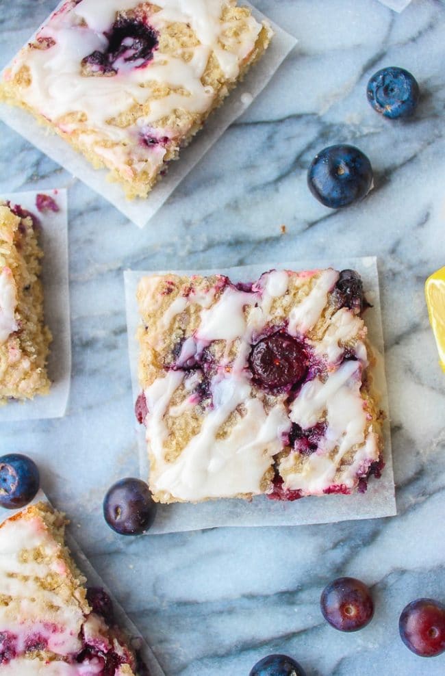 Sweet and chewy Blueberry Coconut Oat Squares on a marble background