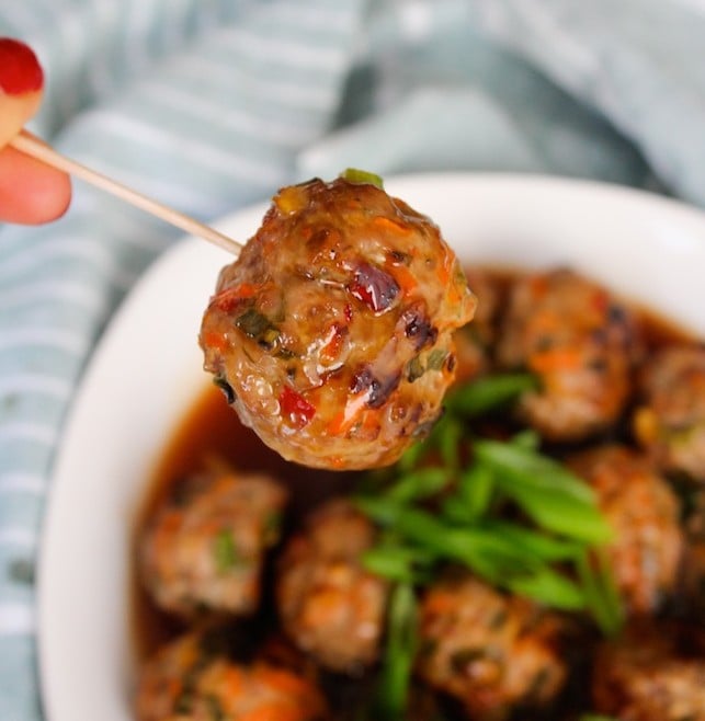 Thai Meatballs held up on a tooth pick