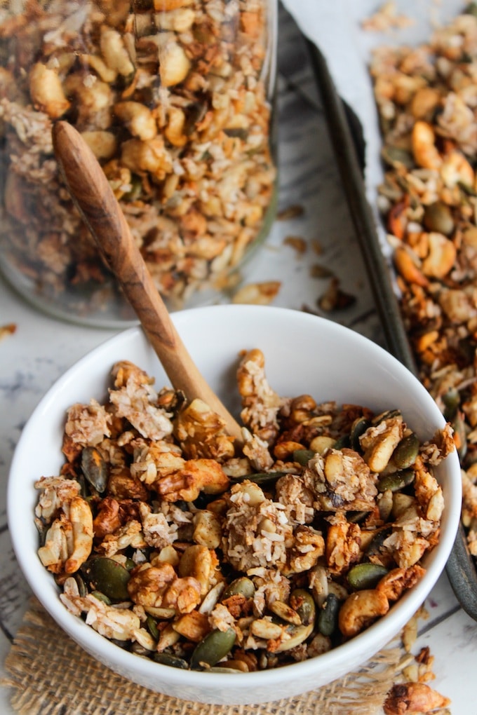 homemade grain free banana granola in a small cereal bowl with a spoon