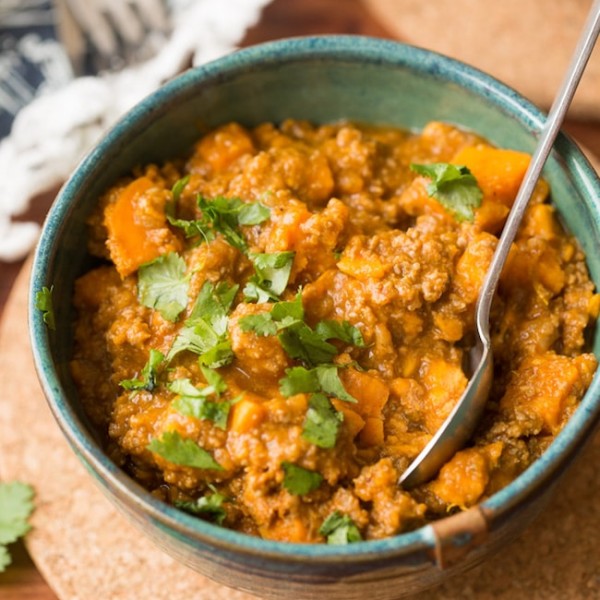 Paleo Chili Sweet Potato in a bowl with a spoon stick out