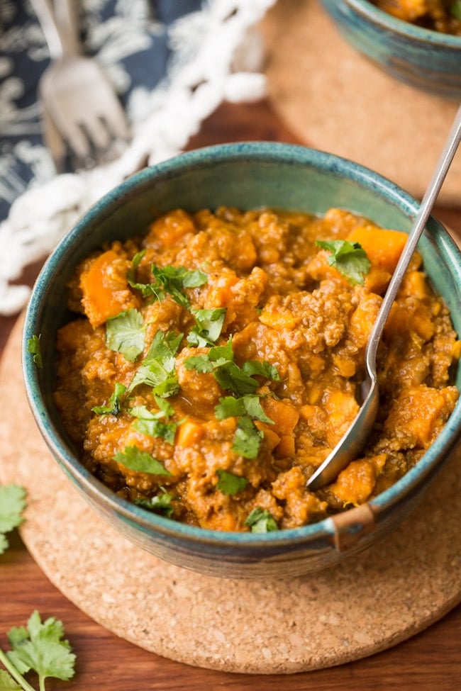 Paleo Chili Sweet Potato in a bowl with a spoon stick out