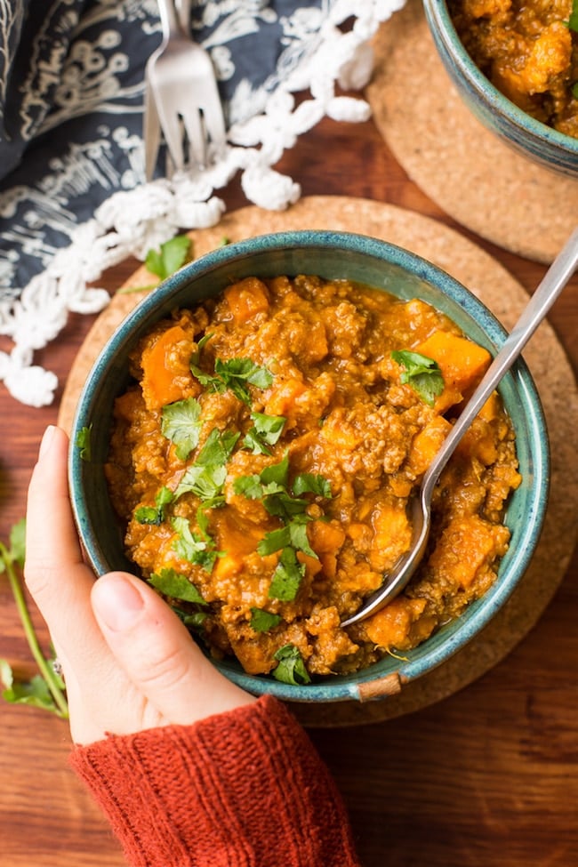 hand holding Paleo Chili Sweet Potato in a bowl