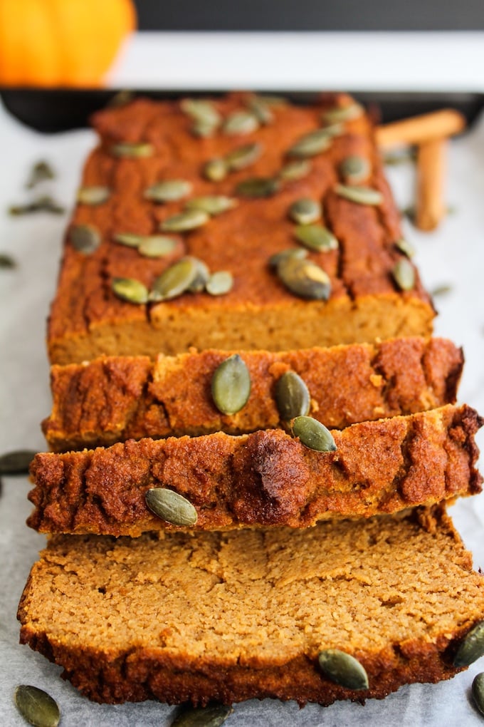 Paleo Pumpkin Bread sliced and topped with pepitas