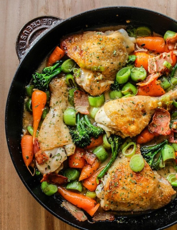 white wine braised chicken and veggies in a cast iron pan