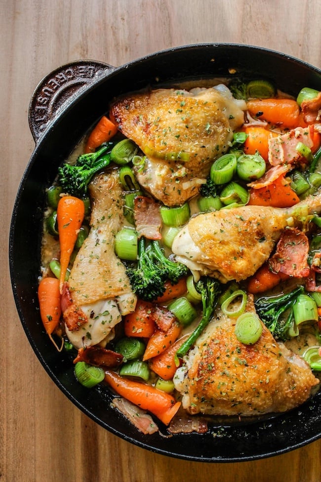 white wine braised chicken and veggies in a cast iron pan