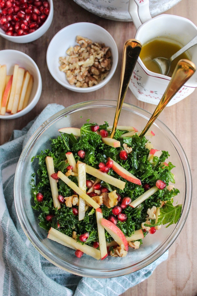 a big salad bowl of Kale Pomegranate Salad with Honey Mustard Dressing