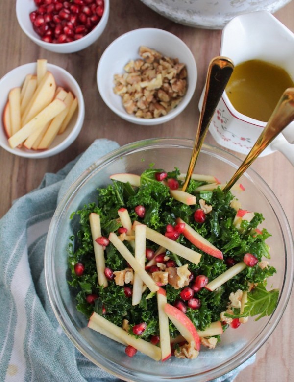 Winter Kale Pomegranate Salad: crisp apples, toasted walnuts, massaged kale and ruby red pomegranate seeds topped in a sweet and tangy honey mustard dressing.