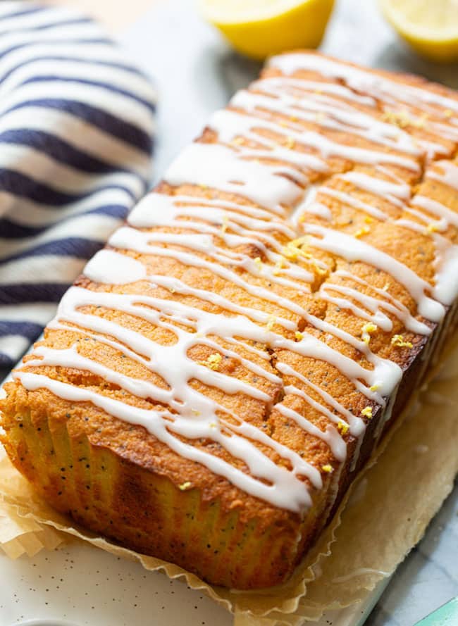 unsliced almond lemon loaf with a lemon drizzle