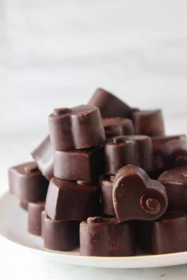 Homemade Dark Chocolate hearts piled on a plate