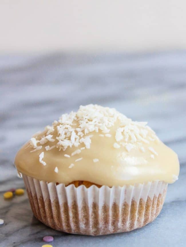 Gluten Free Single Serve Vanilla Cupcake topped with coconut flakes