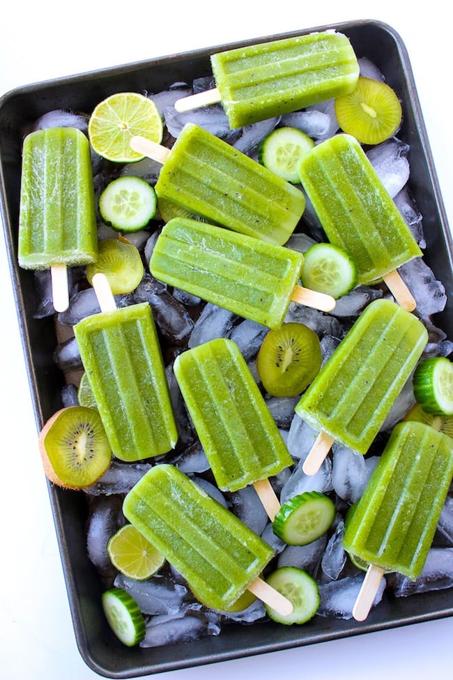 Cucumber Lime Mint Paletas on a baking tray with ice cubes