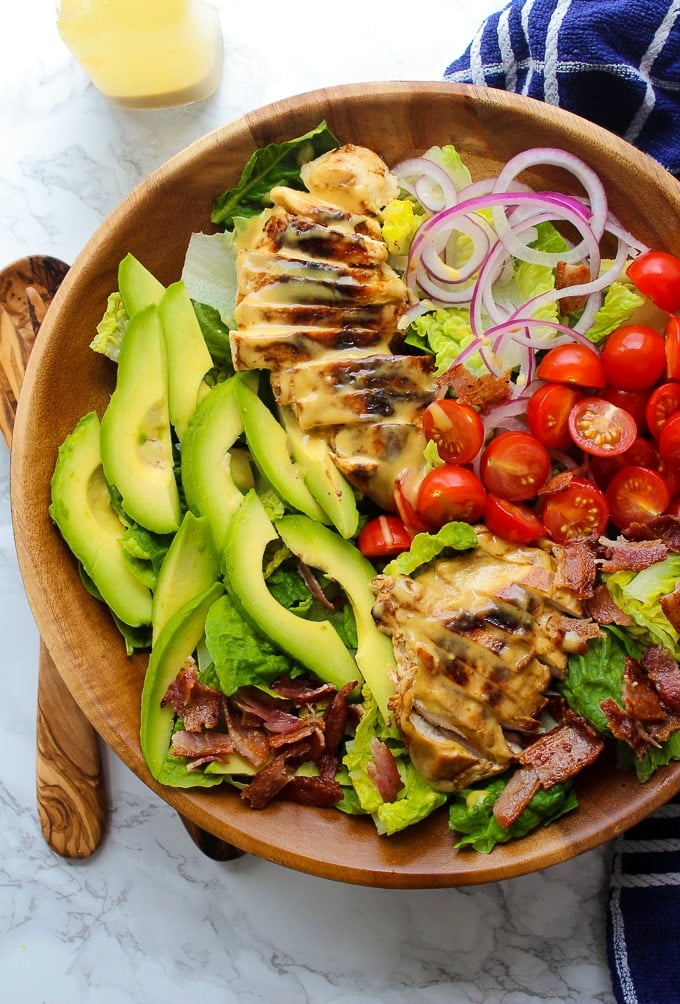 Honey Mustard Chicken Salad with bacon, avocado, sliced red onion, and sliced tomatoes topped with a three ingredient honey mustard dressing. Creamy, tangy and so addictive! Paleo & Dairy Free