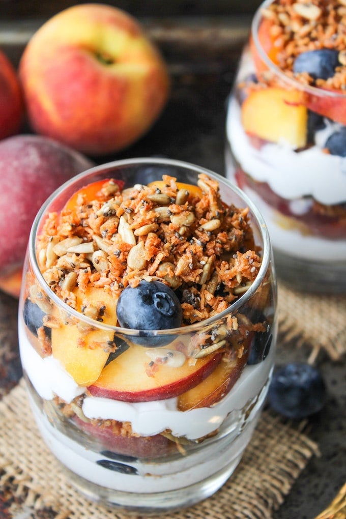 Blueberry & Peach Parfaits - filled with layers of coconut whipped cream, grain free cinnamon granola, and fresh summer fruit. Paleo & Vegan