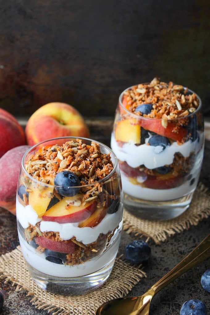 Blueberry & Peach Parfaits - filled with layers of coconut whipped cream, grain free cinnamon granola, and fresh summer fruit. Paleo & Vegan