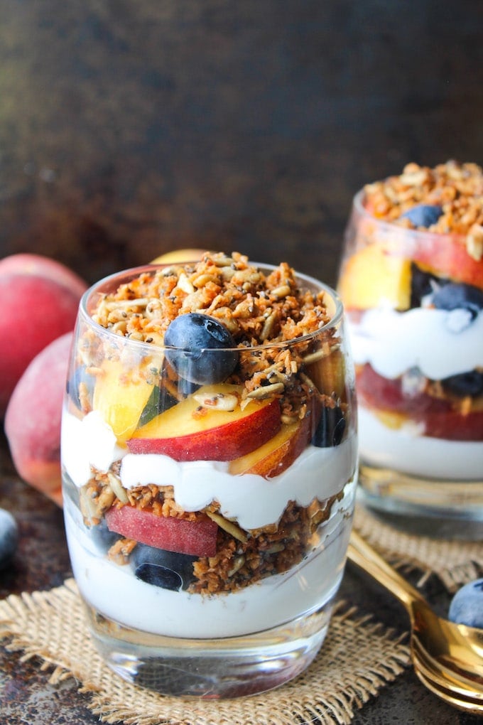 Blueberry & Peach Parfaits - filled with layers of coconut whipped cream, grain free cinnamon granola, and fresh summer fruit. Paleo & Vegan