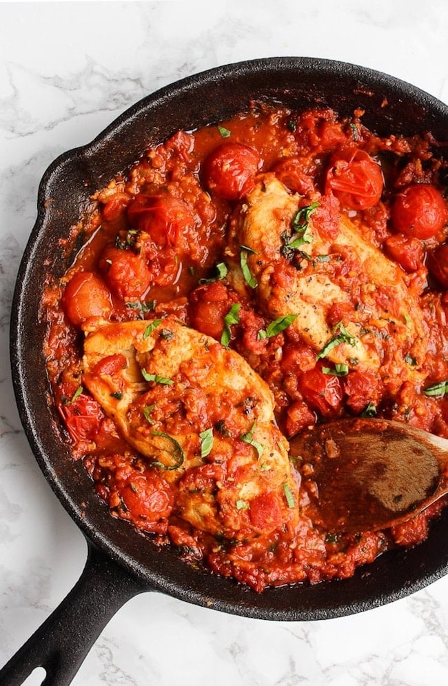 Tomato Basil Garlic Chicken in a cast iron skillet