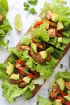 Easy Chicken Fajitas Lettuce Wraps with sautéed onions & peppers, seasoned chicken and topped with diced avocados