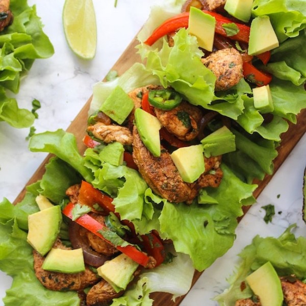 Easy Chicken Fajitas Lettuce Wraps with sautéed onions & peppers, seasoned chicken and topped with diced avocados