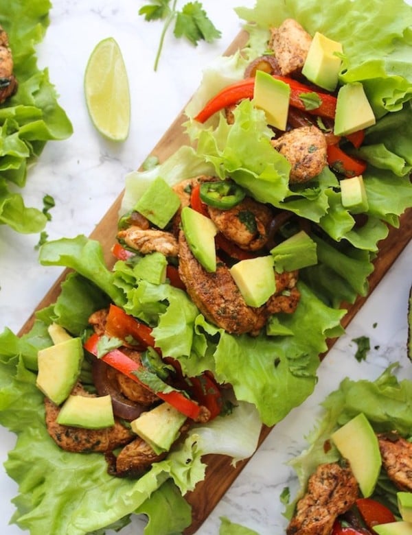 Easy Chicken Fajitas Lettuce Wraps with sautéed onions & peppers, seasoned chicken and topped with diced avocados