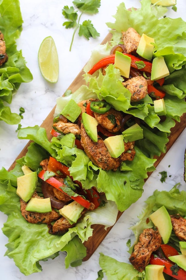 Easy Chicken Fajitas Lettuce Wraps with sautéed onions & peppers, seasoned chicken and topped with diced avocados