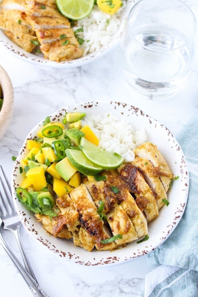 Whole 30 friendly Jerk Chicken in a bowl with rice and mango avocado salsa