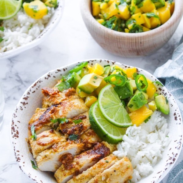 Whole 30 friendly Jerk Chicken in a bowl with rice and mango avocado salsa