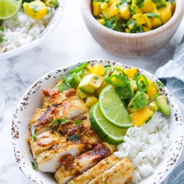 Whole 30 friendly Jerk Chicken in a bowl with rice and mango avocado salsa