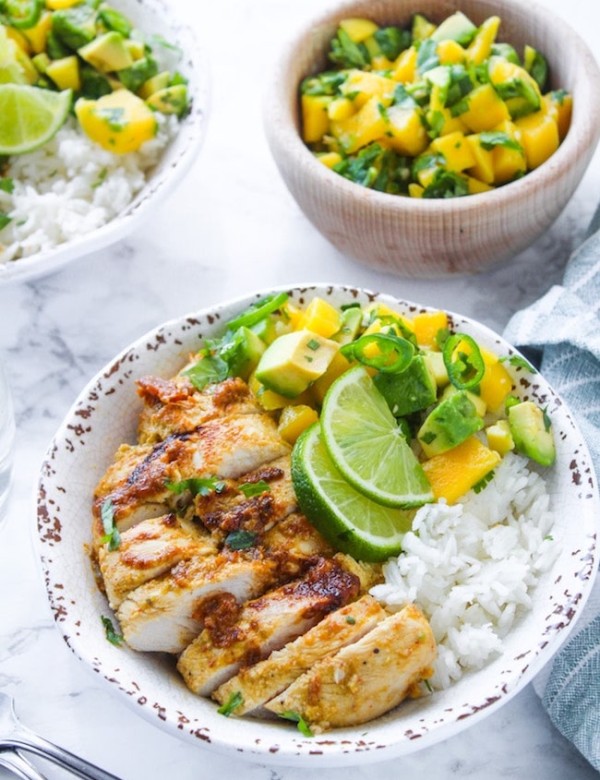 Whole 30 friendly Jerk Chicken in a bowl with rice and mango avocado salsa