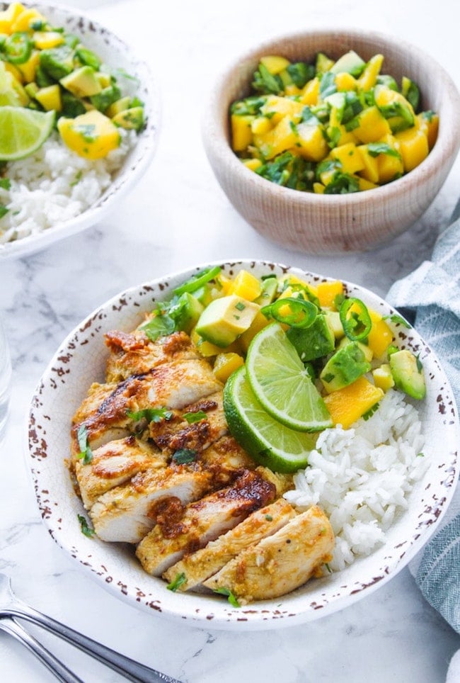Whole 30 friendly Jerk Chicken in a bowl with rice and mango avocado salsa