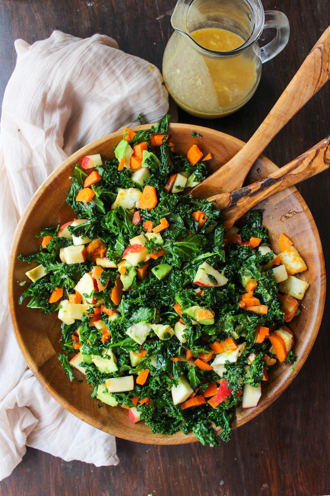 Crunchy Carrot Apple & Massaged Kale Salad topped with halloumi, avocado, seeds and a mustardy almond butter dressing | grain free + gluten free + vegetarian