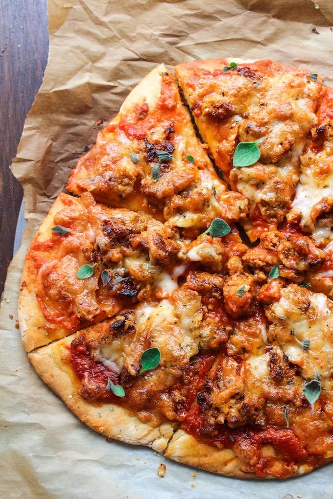 A simple gluten free pizza crust recipe topped with mozzarella cheese, chorizo sausage and fresh herbs
