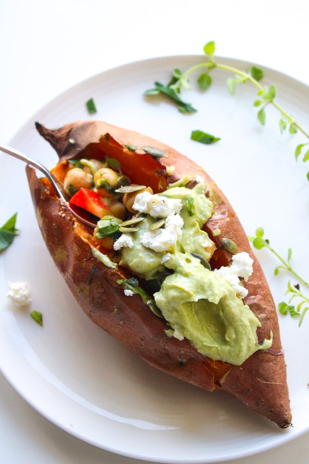 Mediterranean stuffed sweet potatoes with marinated chickpeas on a plate