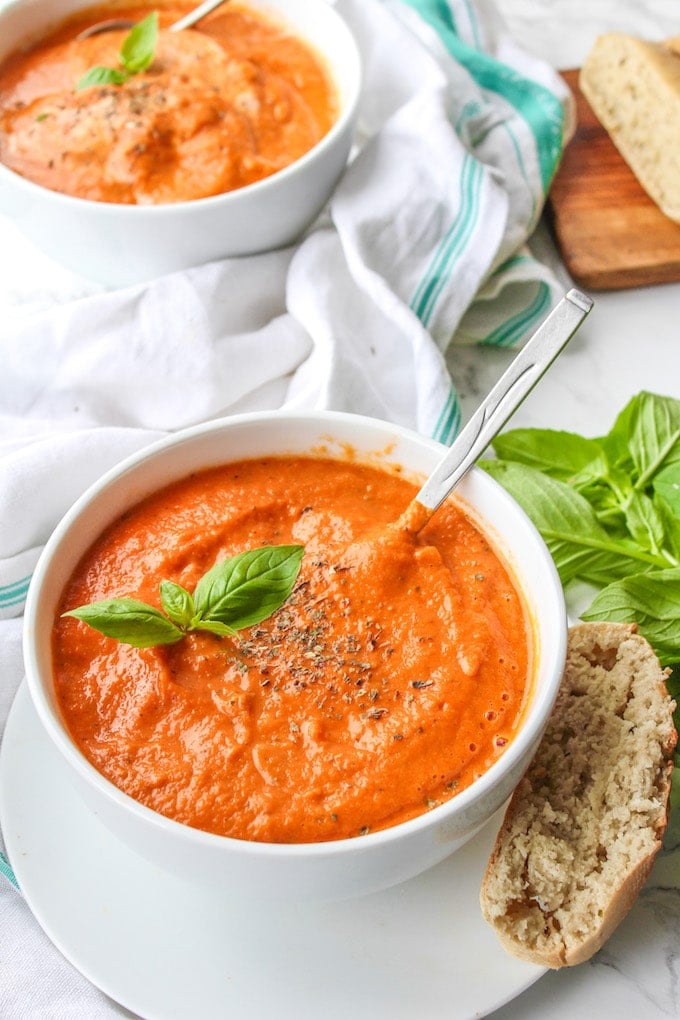 Creamy Roasted Tomato Soup - a fuss free, cool weather comfort. Serve alongside a loaf of crusty French bread and top with fresh basil | paleo + vegan 