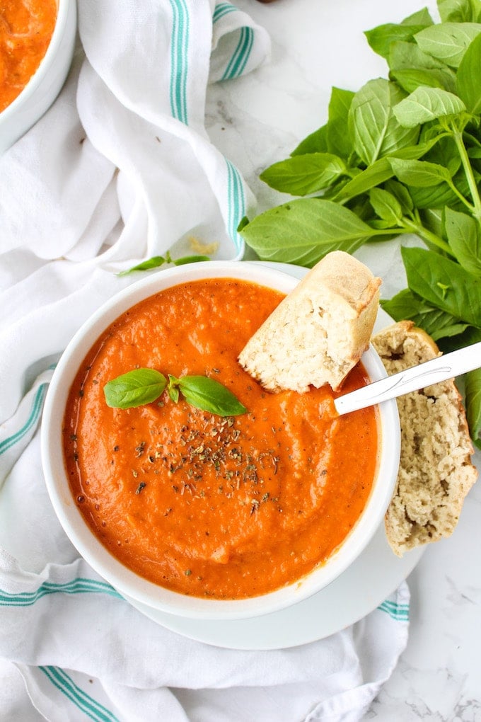 Creamy Roasted Tomato Soup - a fuss free, cool weather comfort. Serve alongside a loaf of crusty French bread and top with fresh basil | paleo + vegan 