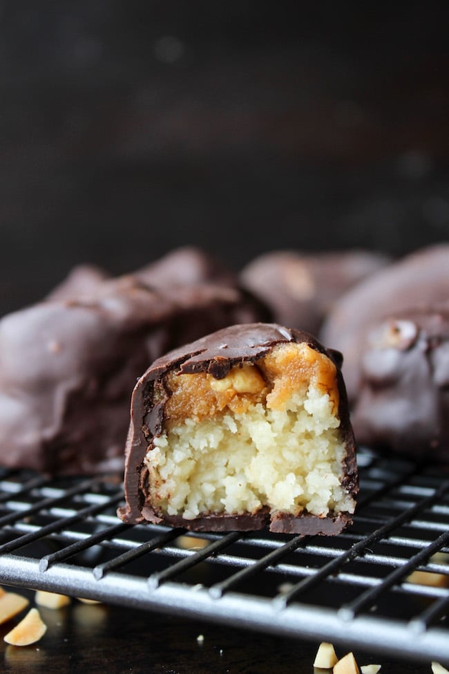 No bake, healthier homemade snickers bars. Made with a coconut almond nougat, topped with a simple vegan caramel sauce and dipped in dark chocolate. Paleo + Vegan + Gluten Free