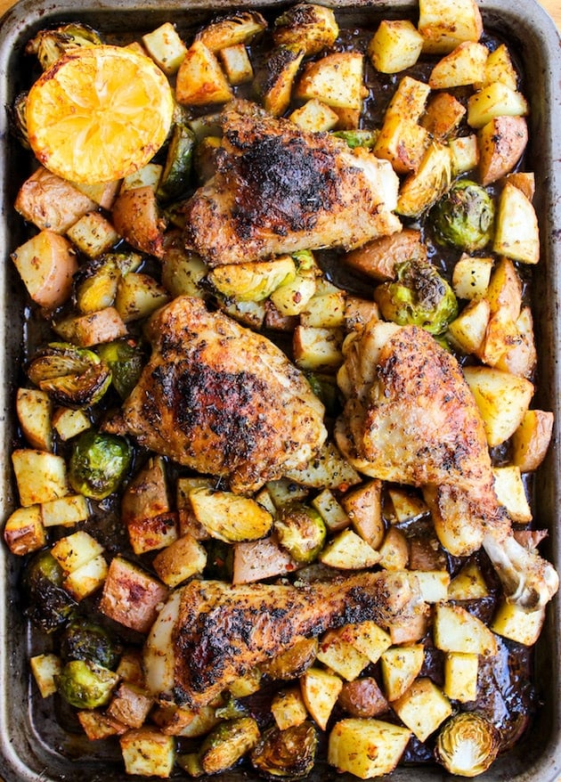 a sheet pan of roasted chicken thighs, potatoes and drumsticks