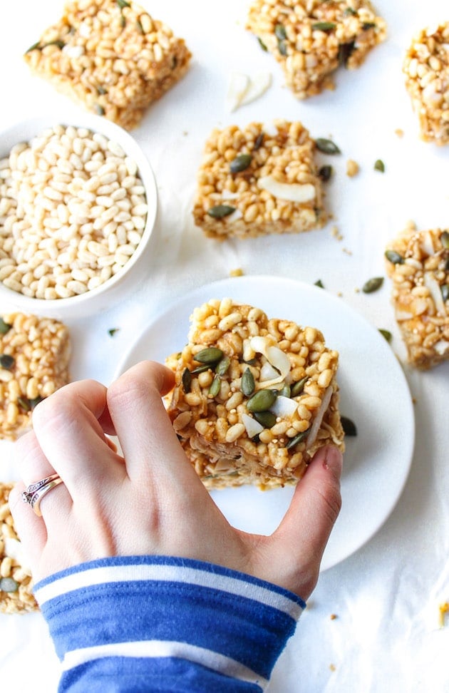 hand picking up a Superfood Vegan Rice Krispie Treats on a plate