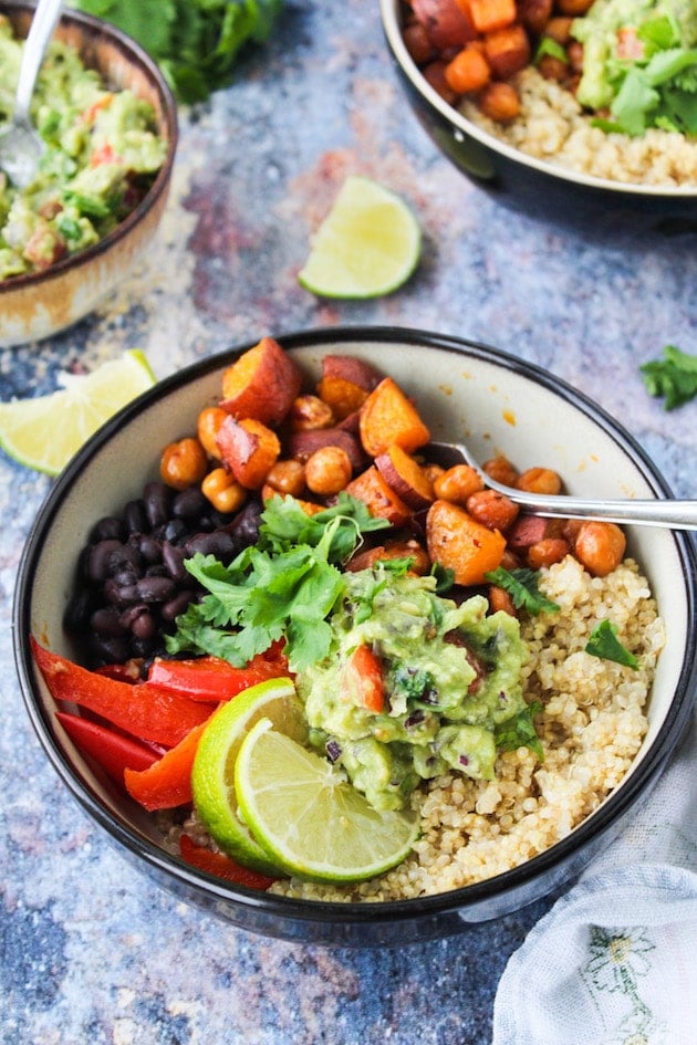 Spicy Chipotle Chickpea Burrito Bowls with roasted sweet potatoes, peppers, black beans and guacamole over a bed of quinoa | vegan + gluten free