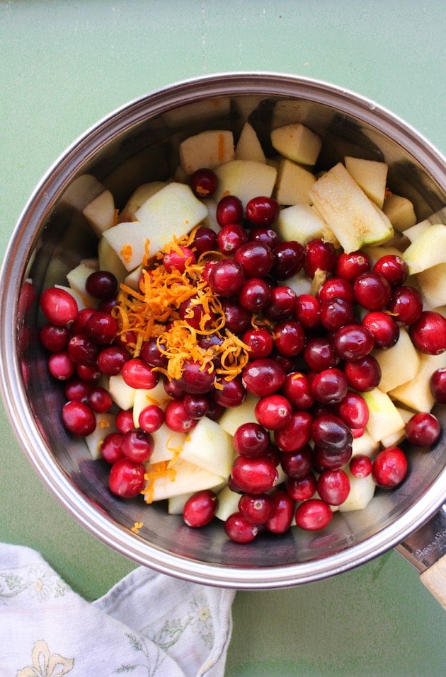 cranberries, apple and orange zest in a sauce pot