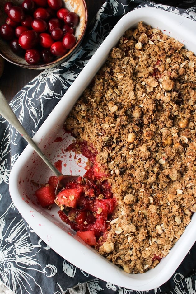 Cranberry Apple Crumble in a baking dish with a spoon