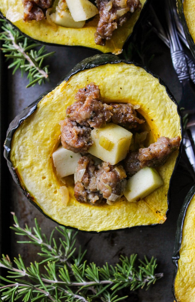 Sausage, apple and rosemary stuffed acorn squash. Only 10 ingredients! Gluten Free + Paleo + Dairy Free Option