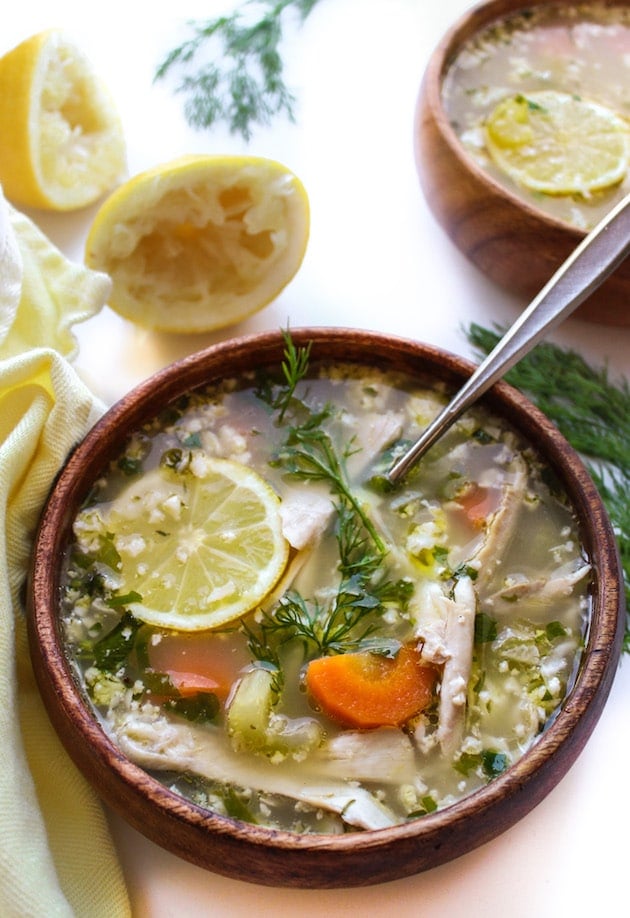 Lemon Chicken Soup with Cauliflower Rice in a bowl top with a lemon slice