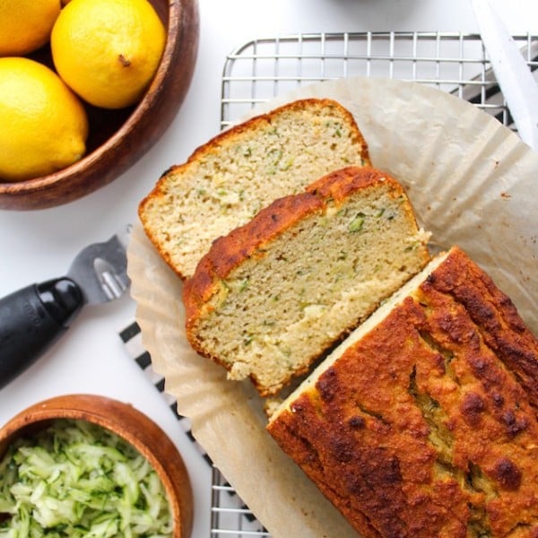 Paleo Lemon and Olive Oil Bread with a couple of slices on a cooling rack