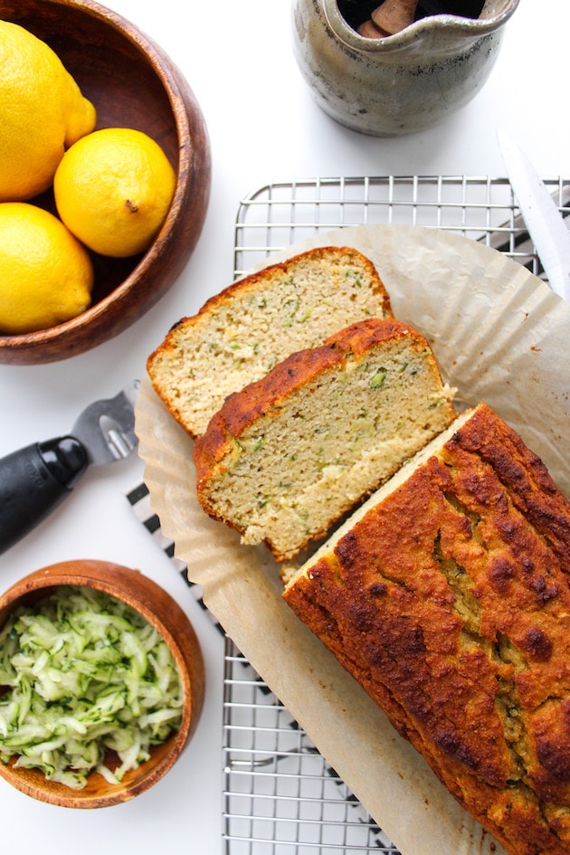 Paleo Lemon and Olive Oil Bread with a couple of slices on a cooling rack